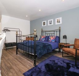 A bedroom with a bed and chair at Chalet 5 in Sherburn