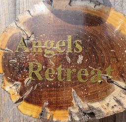 A wooden sign with the text Angels Retreat at Angel's Retreat in Huttoft