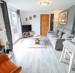 A living room with a sofa and television at Angel's Retreat in Huttoft