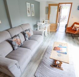 A living room with a sofa, chairs, and table at Angel's Retreat in Huttoft