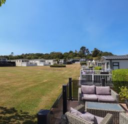 An outdoor area with caravans and patio furniture at 97 Crugan Llanbedrog