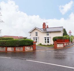 A house with a surrounding hedge and trees at Bryn Offa cottage Holywell