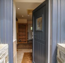 An entrance with a front door and shelving unit at Buzzards Breg in Builth Wells