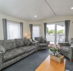 A living room with sofas and a coffee table at The Cotswold Holiday Lodge in Evesham
