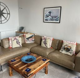 A living room with a sofa and coffee table at Sunrise Apartment in Weymouth