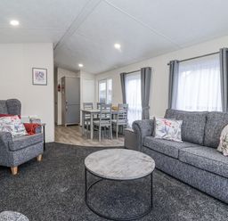 A living room with a sofa and coffee table at Happy Daze in Carnaby near Bridlington