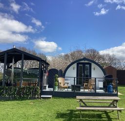 A cabin with a deck and chairs at Cherry Pod near Hookagate Meole Brace
