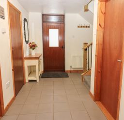 A hallway with a front door and a table at Summerseat in Kirkby Stephen