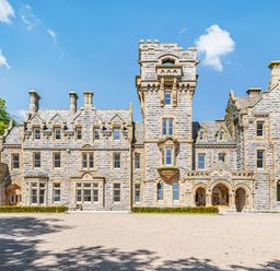 An exterior view of a stone mansion with multiple windows and towers at The Elizabeth Suite Stone Cross Mansion in Ulverston