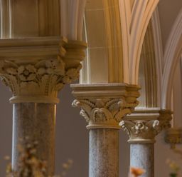 A close up of decorative stone columns and arches inside a building at The Alfred Suite Stone Cross Mansion in Ulverston
