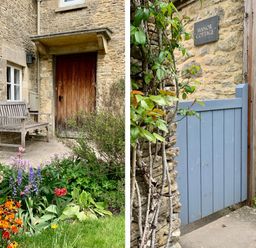 A wooden bench next to a door with flowers and plants in front at Manor Cottage Poulton and a blue wooden gate attached to a stone wall with a sign Manor Cottage at Manor Cottage Poulton