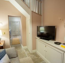 A living room with a sofa and TV on a cabinet at The Tower in Kirklinton near Longtown