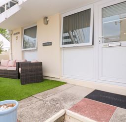 An outdoor area with a sofa and table at Driftwood in Marazion