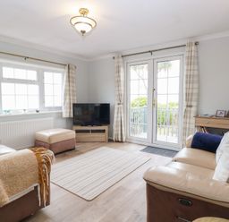 A living room with a sofa and television at Seaward in Trimingham