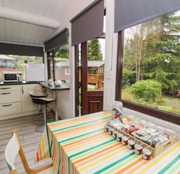 A kitchen with a table and chairs at Babbling Brook in Bron Aber near Blaenau Ffestiniog