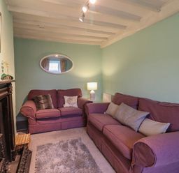 A living room with two sofas and a lamp at Preswylfa in Ffestiniog