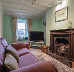 A living room with a sofa and television at Preswylfa in Ffestiniog