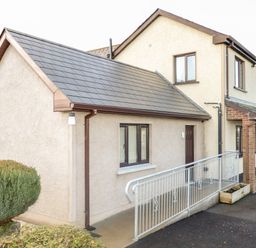 Exterior of a two-story house with a single-story extension and metal railing at Derriens Farmhouse in Letterbreen County Fermanagh