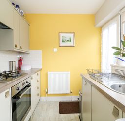 A kitchen with a gas stove oven sink and countertop at The Lobster Pot in Overstrand
