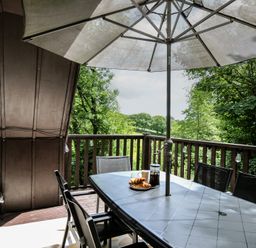 An outdoor dining area with a table and chairs at Hideaway Cottage St Ann's Chapel, Cornwall