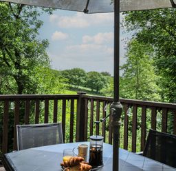 A table with drinks and pastries on a balcony at Hideaway Cottage, St Ann's Chapel, Cornwall