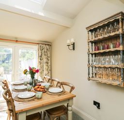 A dining room with a table set for meal at Mallards in Bourton-On-The-Water