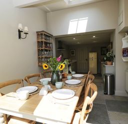 A dining room with a table set for meal at Mallards in Bourton-On-The-Water