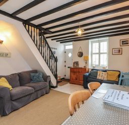 A living room with a sofa and table at Menuchah in Criccieth