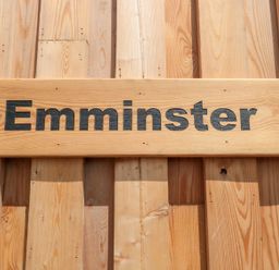 A wooden sign with the word Emminster on a wooden wall at Emminster in Nottington near Weymouth