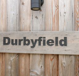 A wooden sign displaying the name Durbyfield in Nottington near Weymouth