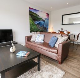 A living room with a sofa and coffee table at Durbyfield in Nottington near Weymouth