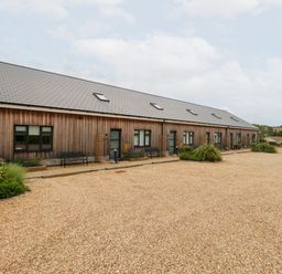 An outdoor area with a building and benches at Egdon Heath Nottington near Weymouth