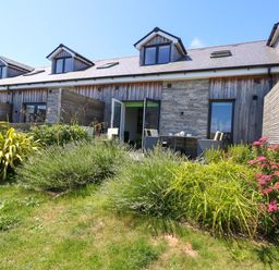 An outdoor area with garden and seating at Overcombe Mill in Nottington near Weymouth