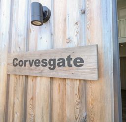 A wooden sign with the name Corvesgate at Corvesgate in Nottington near Weymouth