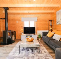 A living room with a sofa and TV at Howgills Retreat Gatebeck near Kirkby Lonsdale
