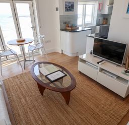 A living room with a view of the sea at Seagull in Lyme Regis