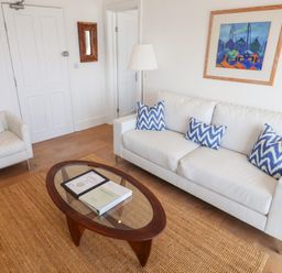 A living room with a sofa and coffee table at Seagull in Lyme Regis