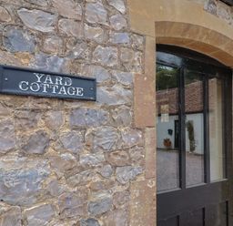 An entryway with a sign reading Yard Cottage at Yard Cottage in Rousdon