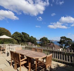 An outdoor terrace with a table and chairs at Westhaven in Lyme Regis