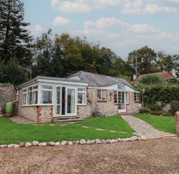 A bungalow with garden and pathway at Penny Plot Cottage in Lyme Regis