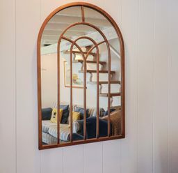 A mirror reflecting a staircase and a couch at Cleve Cottage in Lyme Regis