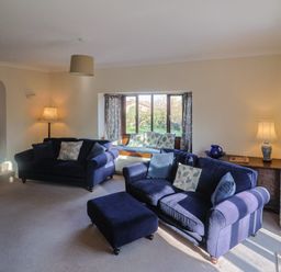 A living room with sofas and a coffee table at High Cliff Orchard in Lyme Regis