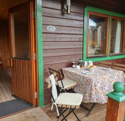An outdoor patio with a table set for breakfast at 10 Pinewood Retreat in Pinewood