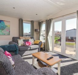 A living room with a sofa and coffee table at Away Daze in Carnaby near Bridlington