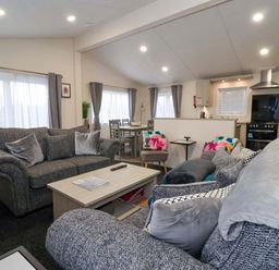 A living room with a sofa and coffee table at Brighter Daze in Carnaby near Bridlington