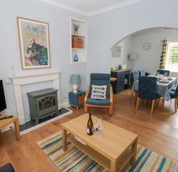 A living room with a television and coffee table at Longmoor in Tenby