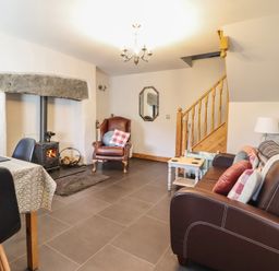 A living room with a fireplace and seating area at Bridgeway House in Blaenau Ffestiniog