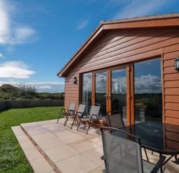 An outdoor area with a table and chairs at Delphine Lodge, Meadow View Lodges, Brean