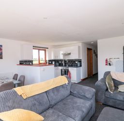 A living room with a kitchen area at Delphine Lodge, Meadow View Lodges in Brean