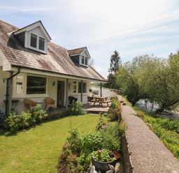 A house with a porch and garden beside a river at Barleside in Dulverton